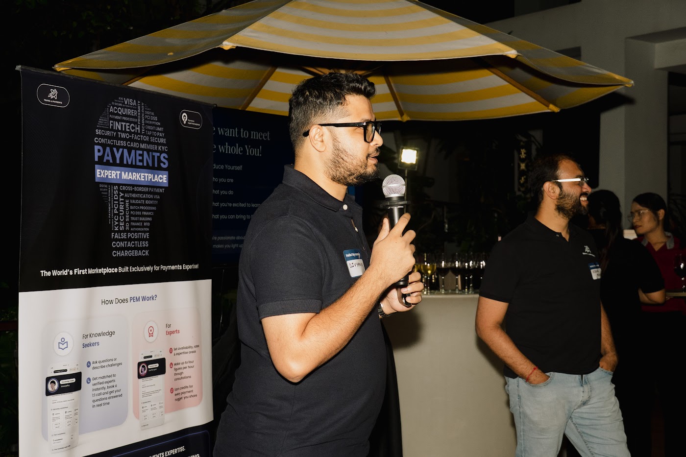 A speaker addressing retreat attendees with a microphone