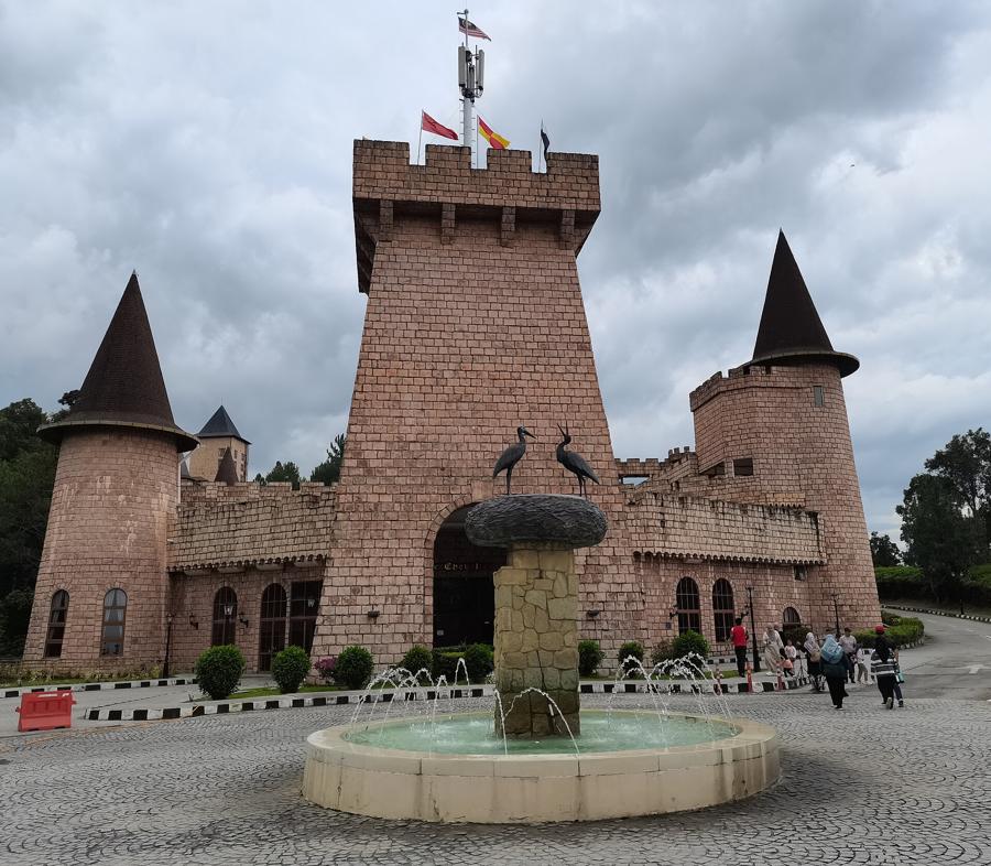 Le Chevalier, a castle with turrets and a stork fountain, opposite Colmar Tropicale