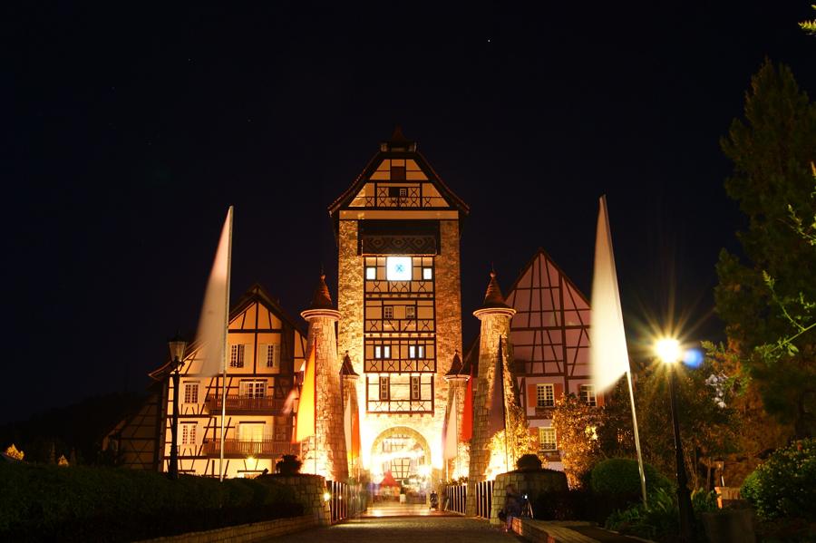 Colmar Tropicale's gate tower lit up at night